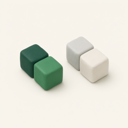 Four rounded clay blocks set in two pairs, one pair in two shades of green and the other in grey and white